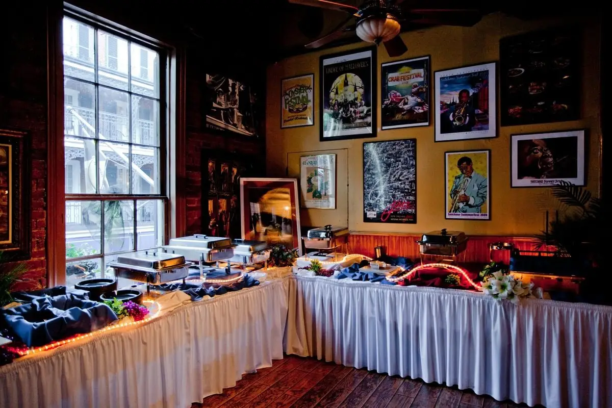The banquet room set with a buffet line, sports art on the walls