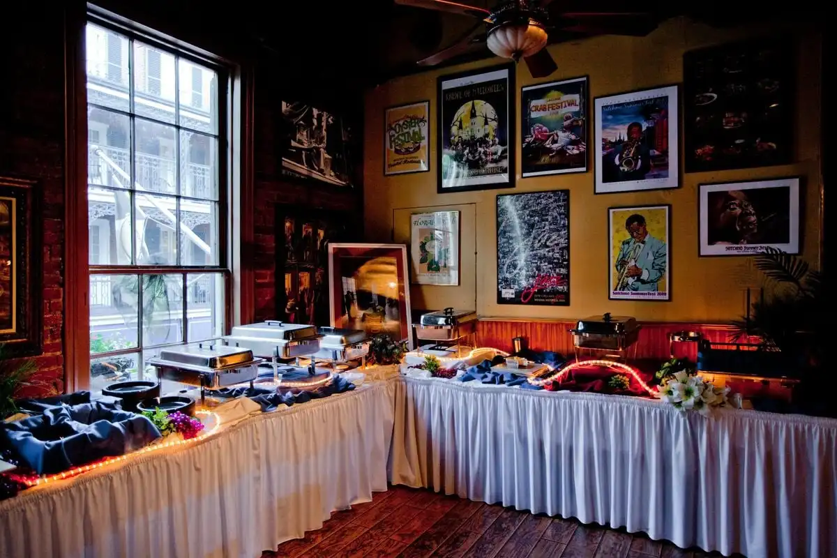 The banquet room set with a buffet line, sports art on the walls