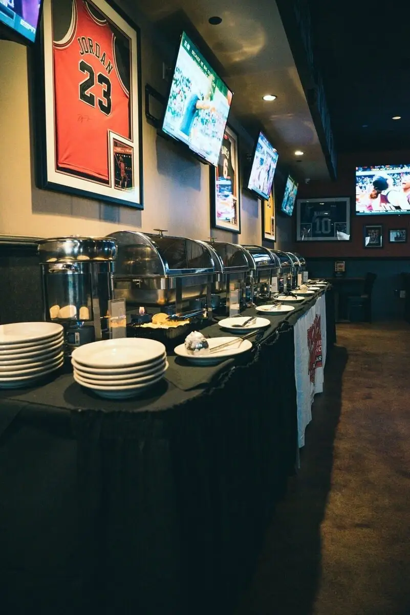 A long buffet line of chafing dishes set for a party