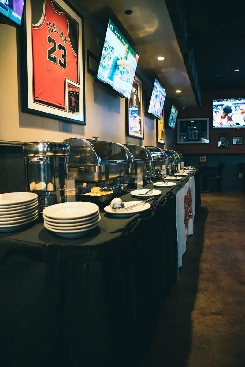 A long buffet line of chafing dishes set for a party