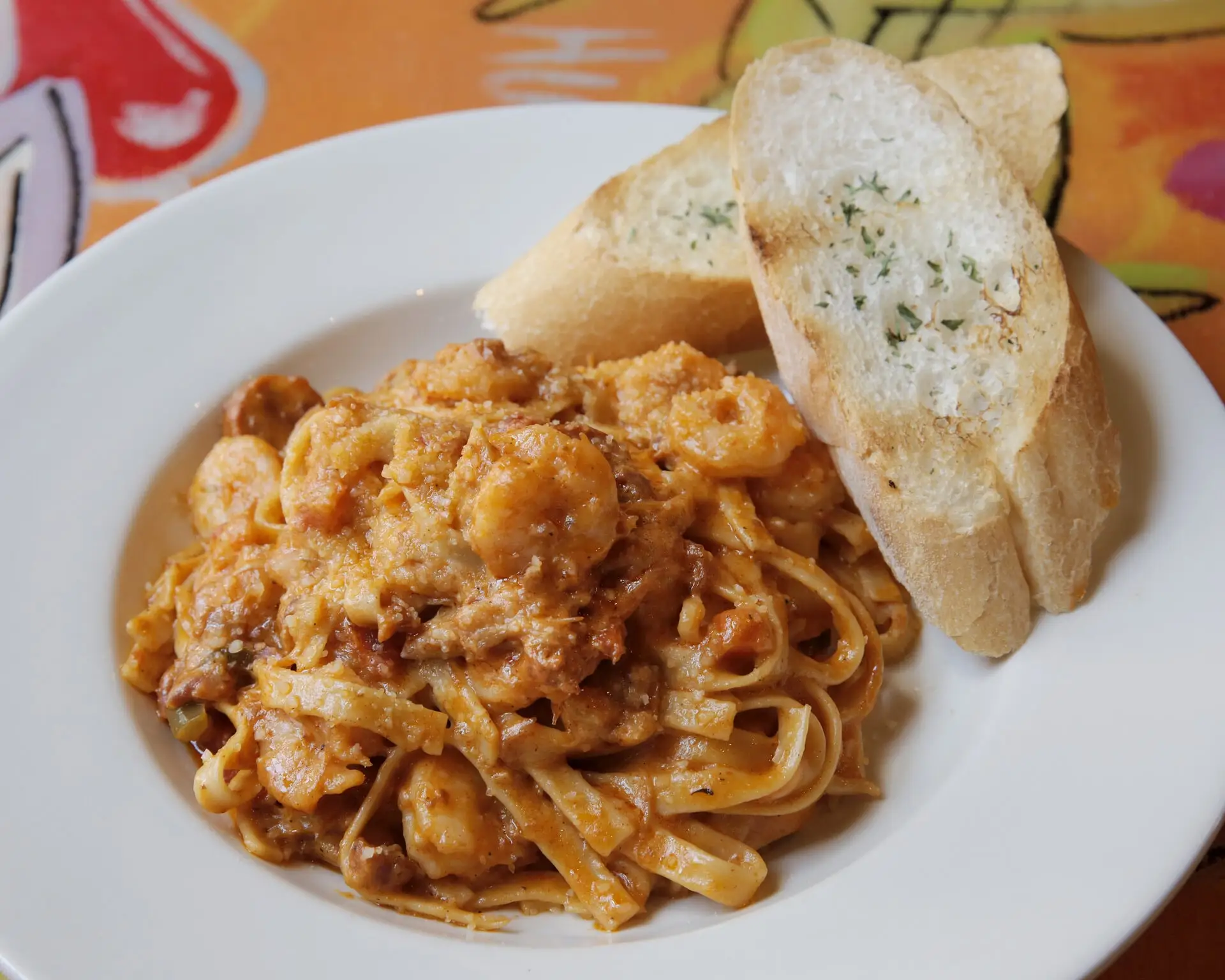 Cajun Jambalaya Pasta with sausage, shrimp and chicken in Creole Alfredo, with garlic bread