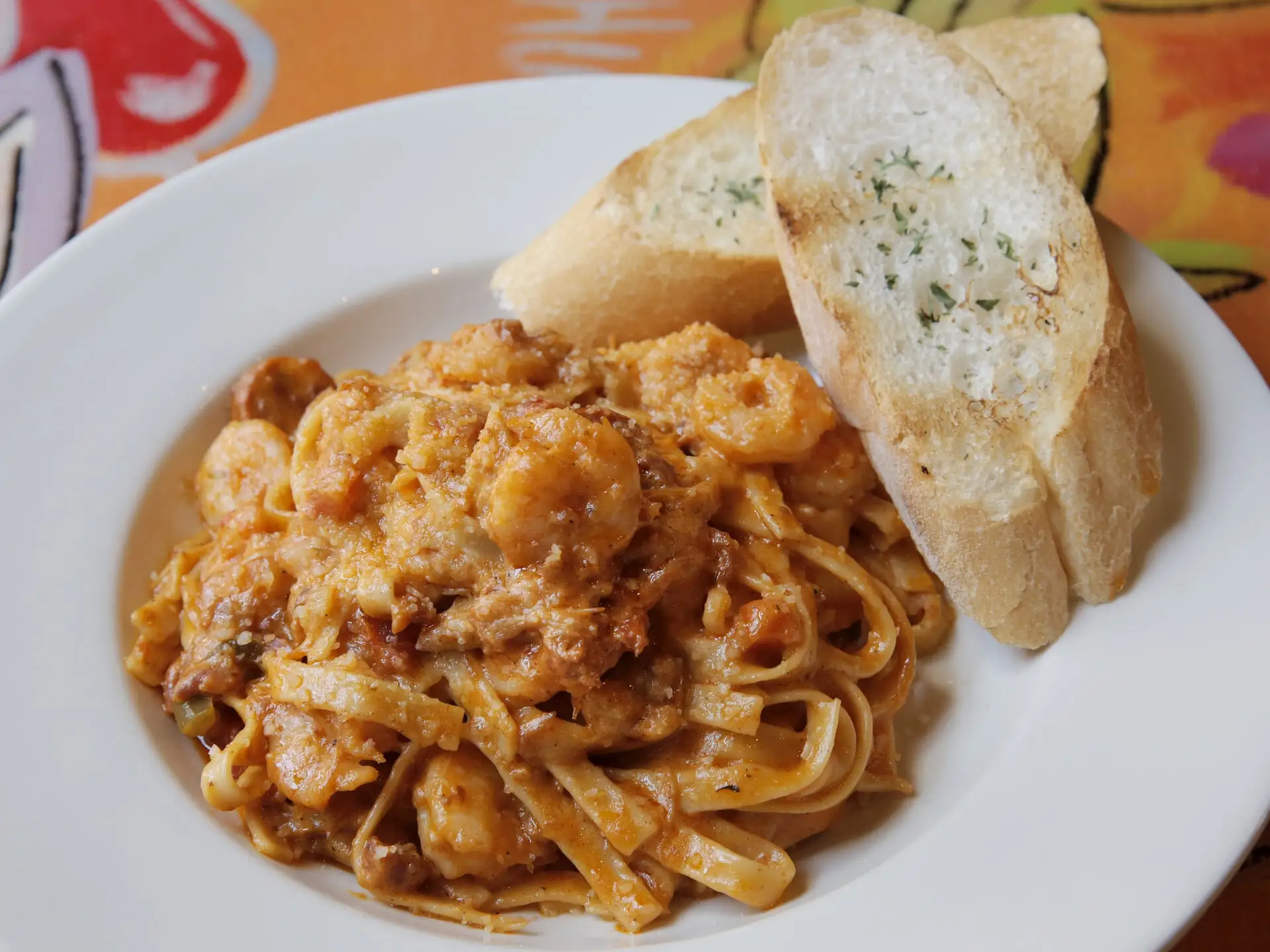 Cajun Jambalaya Pasta with sausage, shrimp and chicken in Creole Alfredo, with garlic bread
