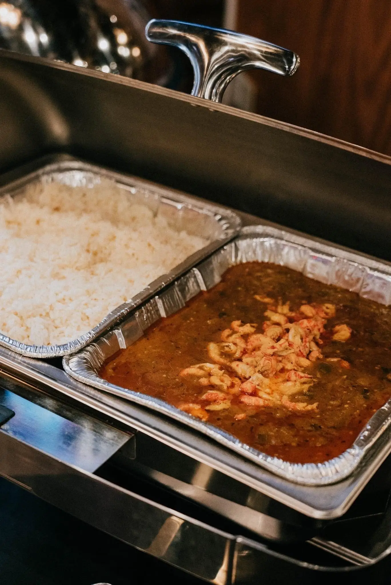 Catering pans of white rice and crawfish étouffée